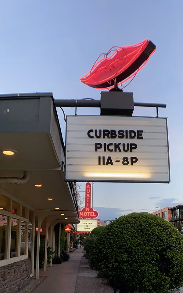 A restaurant with a sign advertising Curbside pickup during the pandemic.