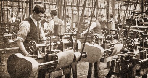 19th Century factory workers operating belt-driven machinery
