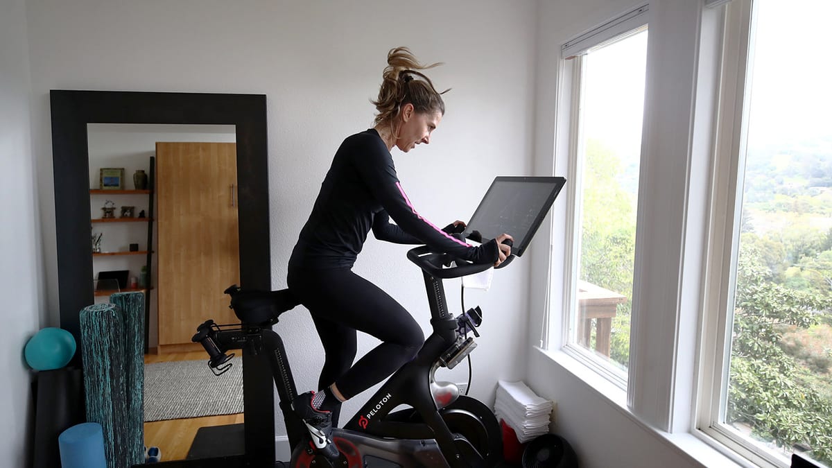 young woman exercising on an indoor stationary bicycle