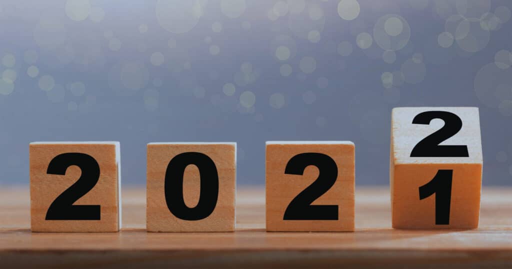 Close-up of four wooden blocks on a tabletop displaying the number 2022.